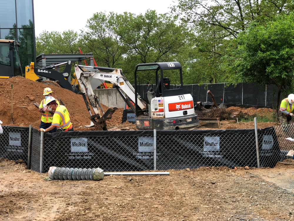 Muller, Inc. crews install super silt fence at construction site.