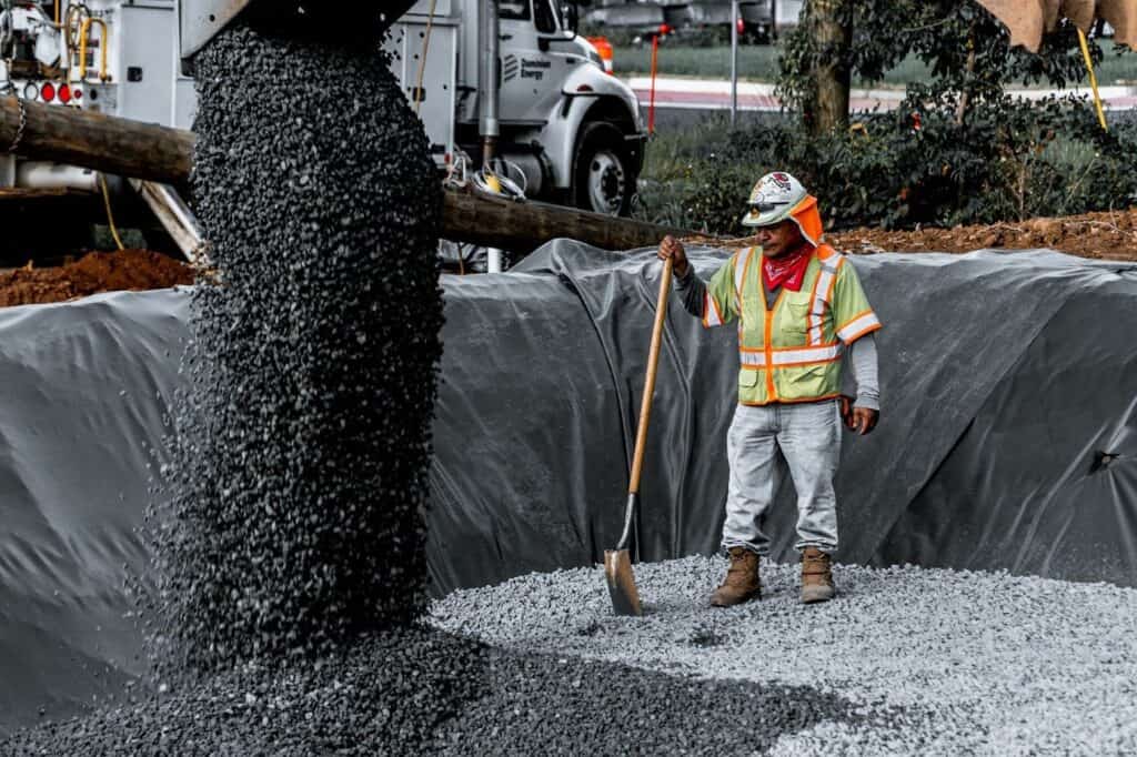 Worker Spreading Gravel