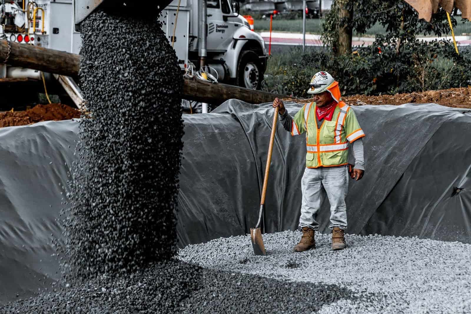 Worker Spreading Gravel