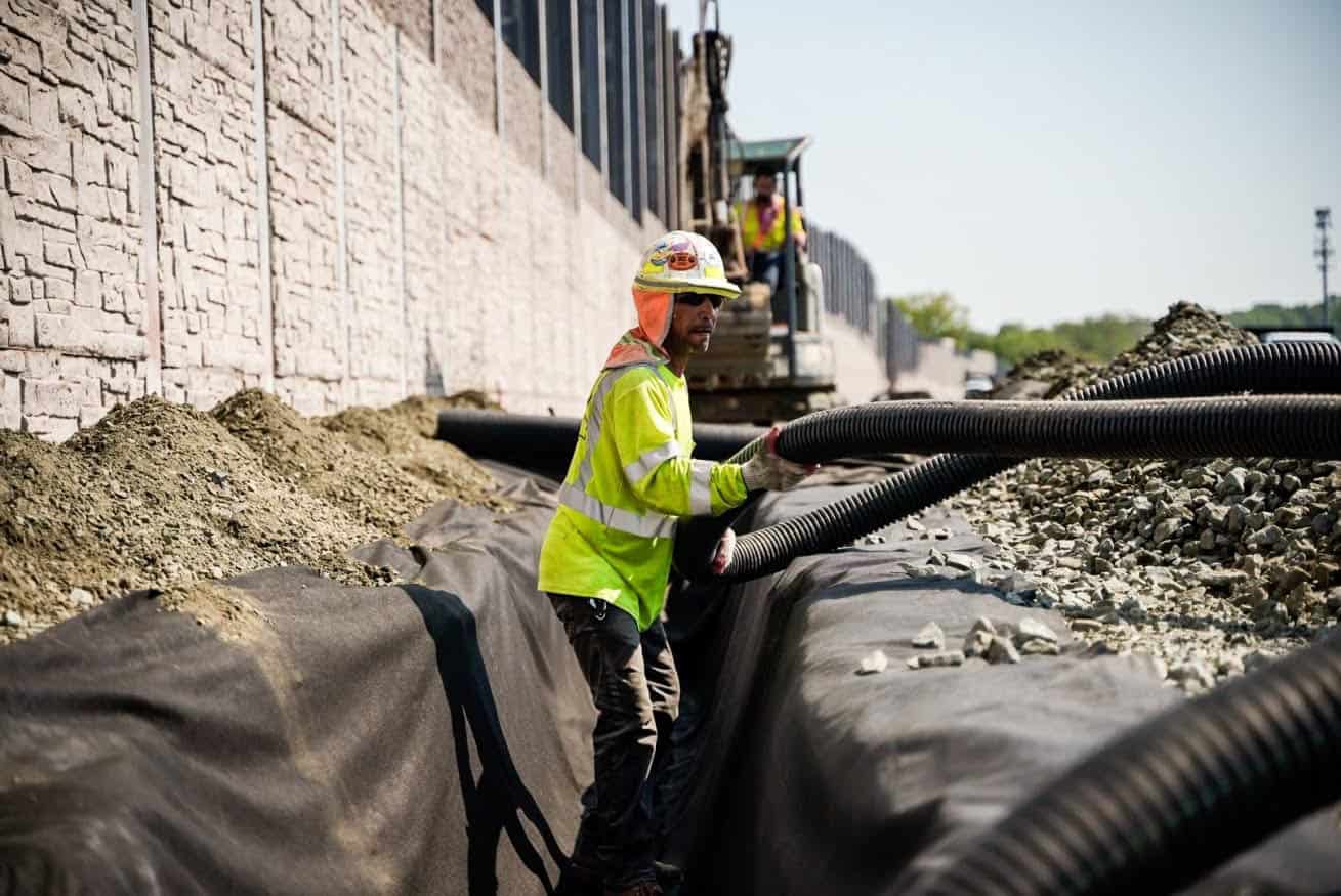 A Muller Inc. worker installing utilities on a construction site. 