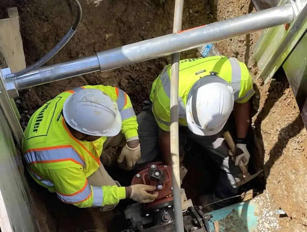 Two Muller, Inc. crew members working on one of the examples of water installation system underground in the DMV area.