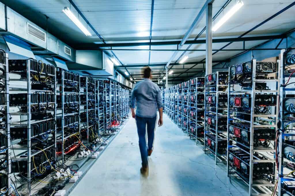 IT business owner walking in high tech data center full of servers and computers.