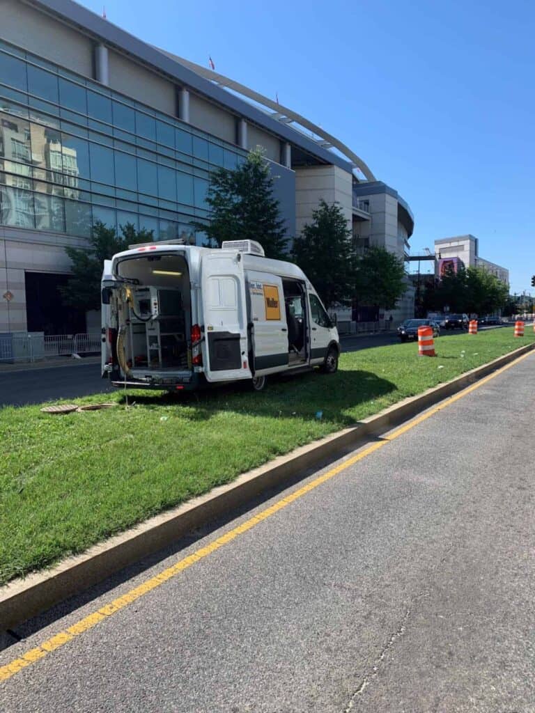 White Muller Inc. truck parked in the grass for water jet excavation services